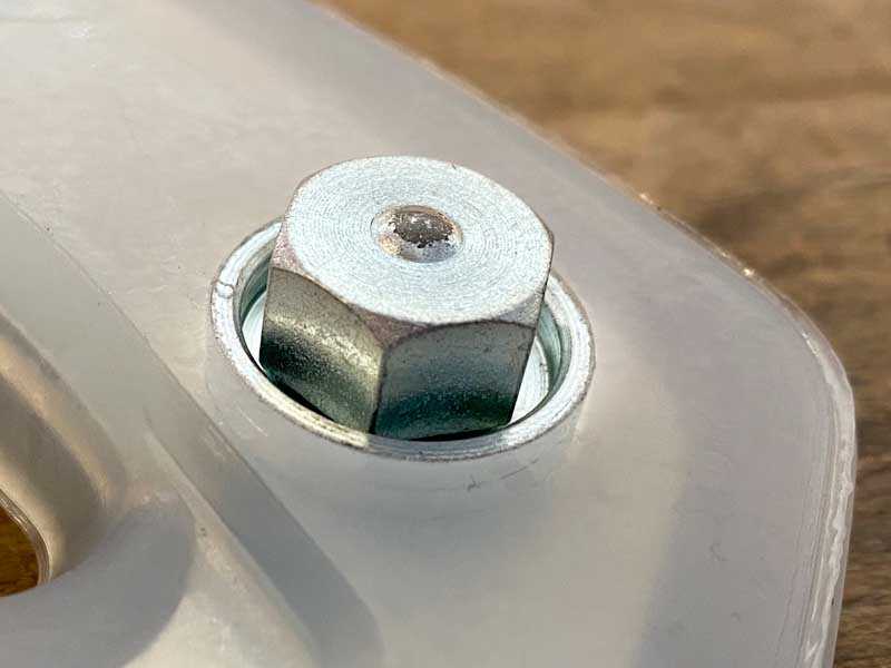 Stud inside the threaded insert of the composite horseshoe