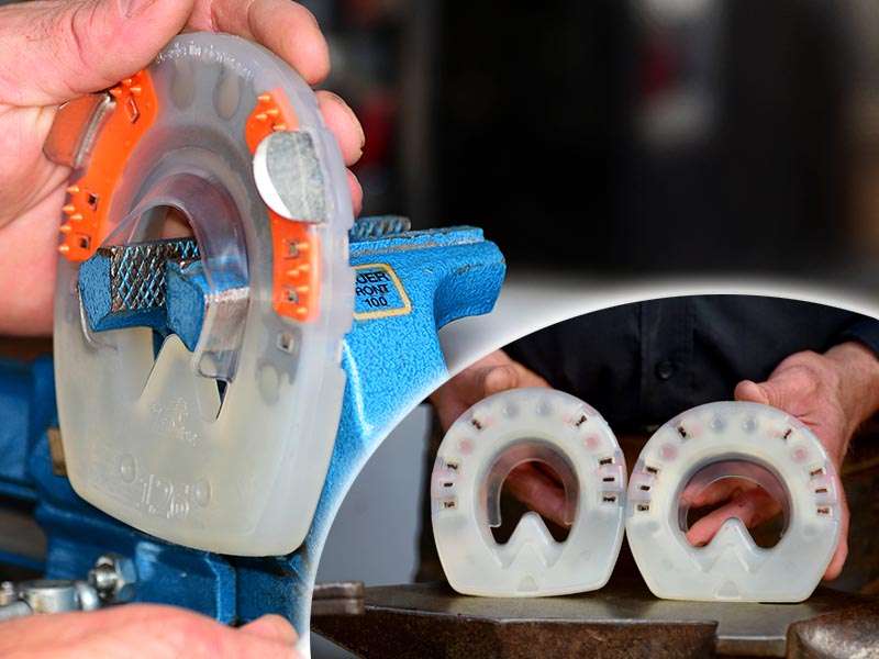 A farrier presents a wider shaped composite horseshoe.
