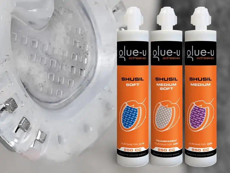 In the background, there is a nailed composite horseshoe with a closed sole that has been filled with a pad material. In front of it is a selection of SHUSIL silicone hoof cushion material from glue-u.