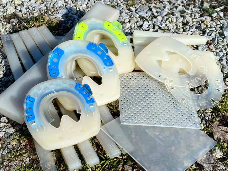 Fers composites avec noyau métallique, cales, plaques en plastique et éléments de soudure en regranulat.