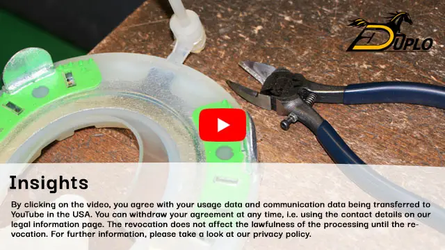 a freshly manufactured composite horseshoe and a pair of pliers are on the workbench