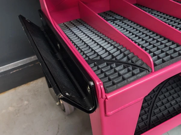 Integrated rasp holders allow easy storage of hoof rasps during work.