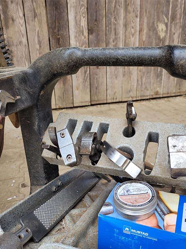 Farrier's tool trolley with hammer, pliers, rasp, Mustad hoof nails and white line filler from andis hoof care.